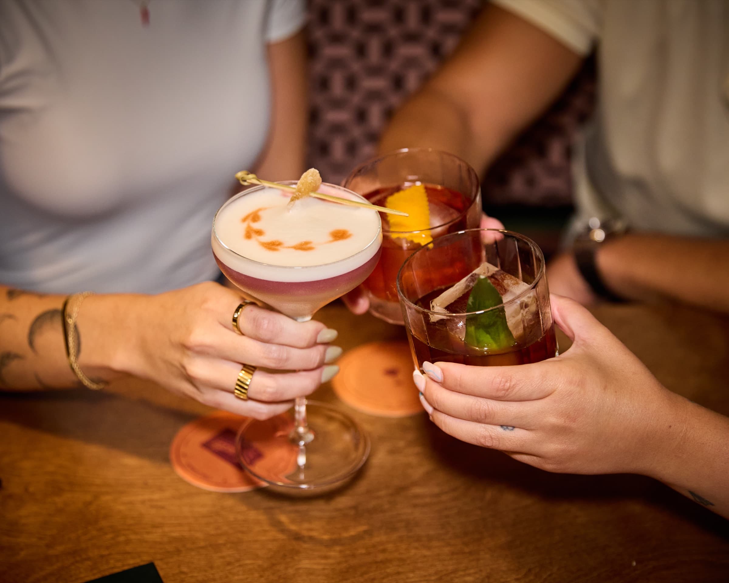 Two cocktails raised in a toast at Cassette